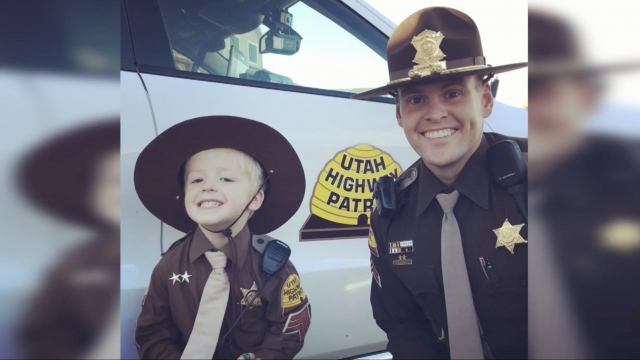Boy poses with officer.