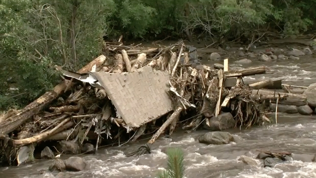 Logs stack up after flash flooding.