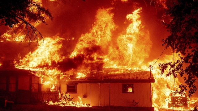 Flames consume a home as the Dixie Fire tears through the Indian Falls community in Plumas County, California.