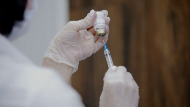 Woman preps a vaccine.