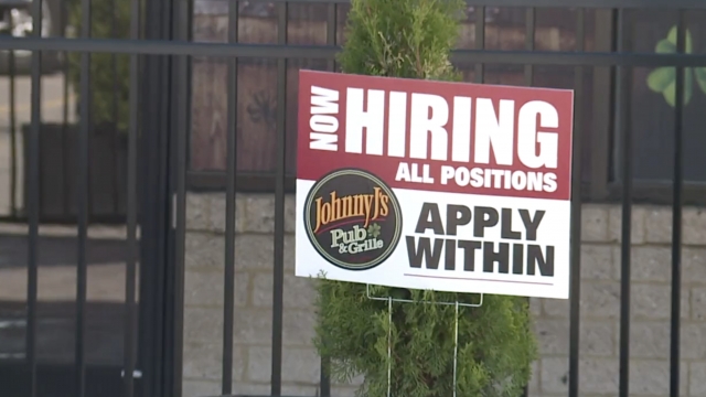 Hiring sign in the yard.