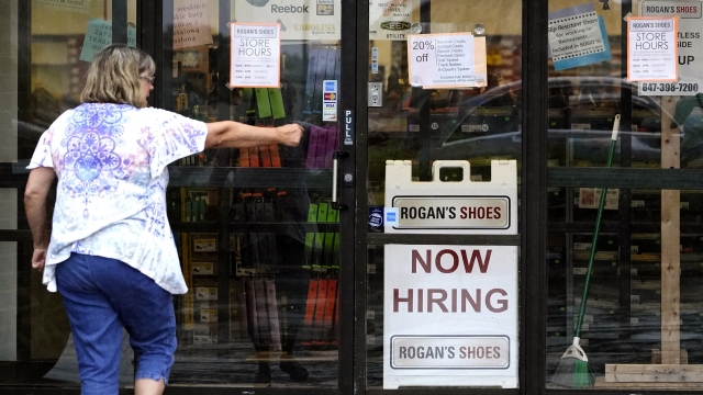 A hiring sign is displayed outside a retail store in Buffalo Grove, Ill.