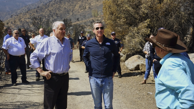 Nevada Gov. Steve Sisolak and California Gov. Gavin Newsom survey wildfire damage.