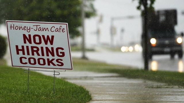 A hiring sign is shown in Downers Grove, Ill.