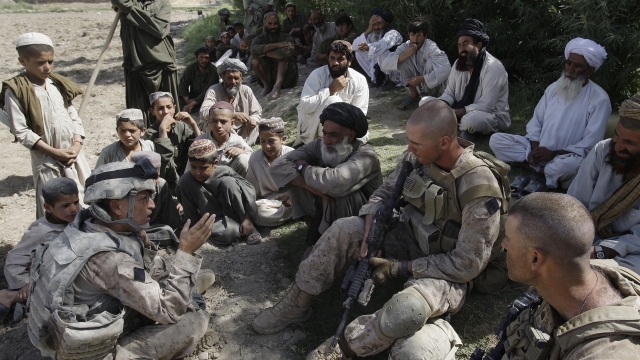U.S. Marines speaking with Afghan villagers.
