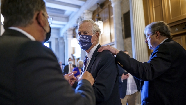 Sen. Angus King, I-Maine, center, speaks with Sen. Gary Peters, D-Mich., left.
