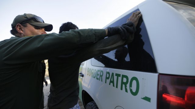 A U.S. Border Patrol agent apprehends a migrant