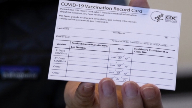 Man holds a vaccine card.