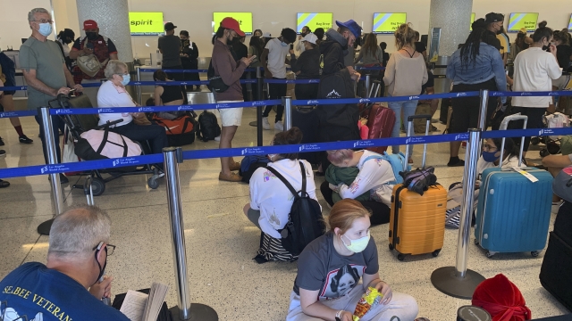 Passengers line up inside the Spirit Airlines terminal at Los Angeles International Airport in Los Angeles.