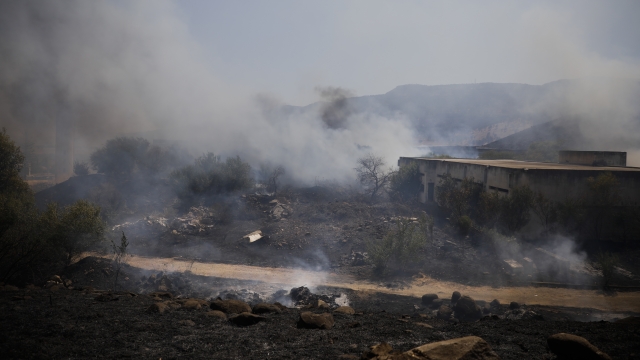 Fields burn following a hit by a rocket fired from Lebanon into Israeli territory