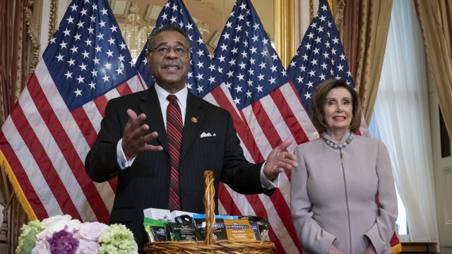Rep. Emmanuel Cleaver of Missouri stands by Speaker of the House Nancy Pelosi.