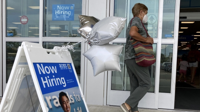 A shopper passes a hiring sign while entering a retail store in Morton Grove, Ill., Wednesday, July 21, 2021.