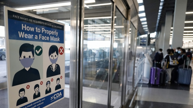 A sign stating face coverings are required is displayed at O'Hare airport in Chicago