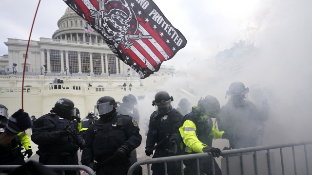 U.S. Capitol Police officers hold off rioters.