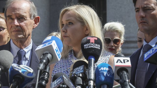 Virginia Giuffre, center, who says she was trafficked by sex offender Jeffrey Epstein