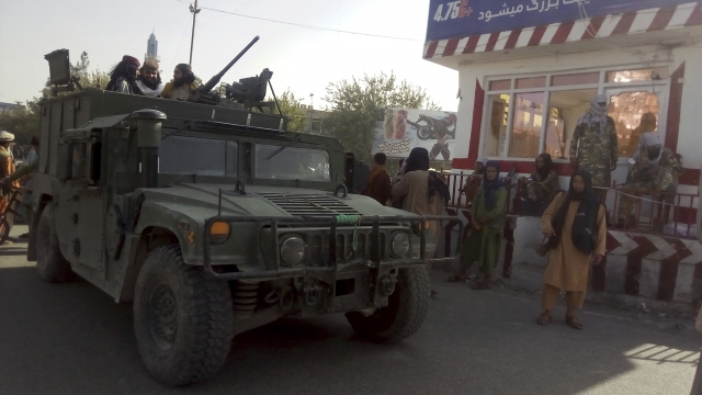 Taliban fighters stand guard at a checkpoint in Kunduz city, northern Afghanistan.