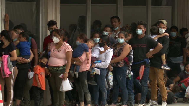 Migrants wait to get COVID testing outside of the Catholic Respite Center in McAllen, Texas