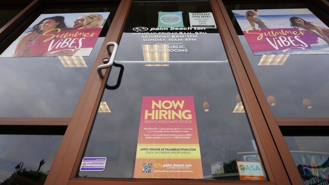 A Now Hiring sign at a business in Richmond, Va., Wednesday, June 2, 2021.