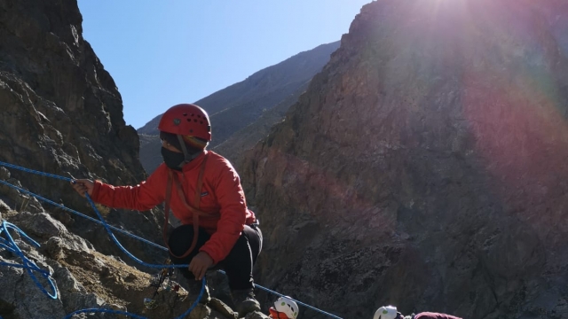 An Afghan woman climbs