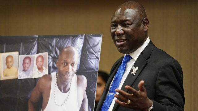 Attorney Ben Crump holds up a picture of Byron Williams, who died in Las Vegas police custody.
