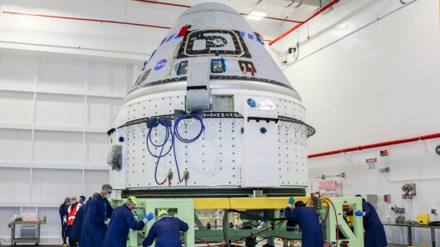 Technicians prepare Boeing's CST-100 Starliner for the company's Orbital Flight Test-2