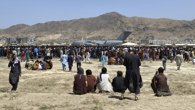 Hundreds of people gather at the international airport in Kabul, Afghanistan.