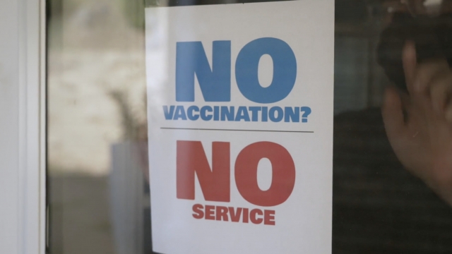 "No Vaccination, No Service" sign.
