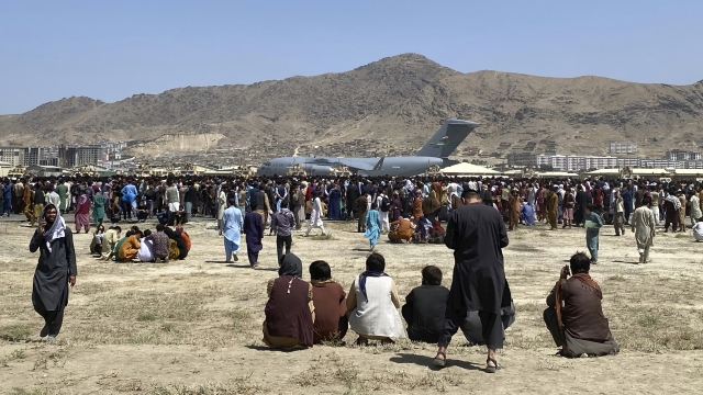 Hundreds of people gather near a U.S. Air Force transport plane at the international airport in Kabul, Afghanistan.