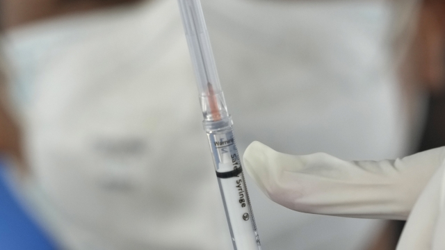 A syringe filled with a dose of the Pfizer COVID-19 vaccine