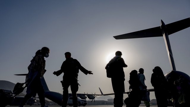 U.S. Air Force Airmen guide evacuees at Hamid Karzai International Airport in Kabul, Afghanistan.