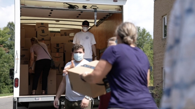 Volunteers load a truck.