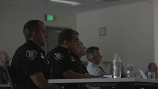 Officers listen to a training
