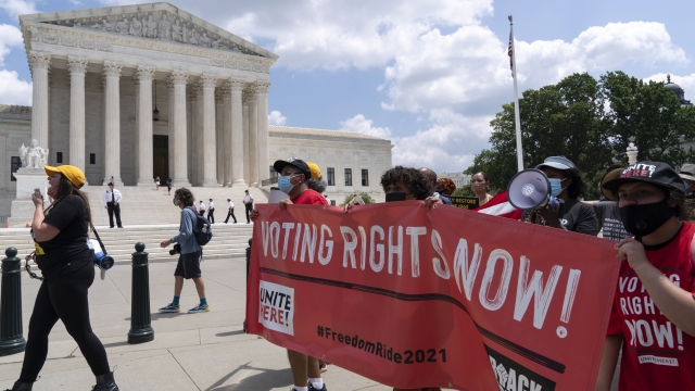 Voting rights activists march outside of the U.S. Supreme Court during a voting rights rally on Capitol Hill on Aug. 2, 2021.