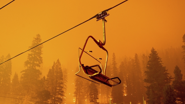 The Caldor Fire burns as a chairlift sits motionless at the Sierra-at-Tahoe ski resort.