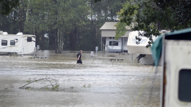 Man walks through flood waters in Magnolia, Mississippi in the aftermath of Hurricane Ida.