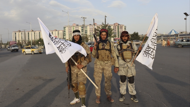 Taliban fighters hold Taliban flags in Kabul, Afghanistan on Monday, Aug. 30, 2021.