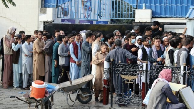 Afghans stand in line
