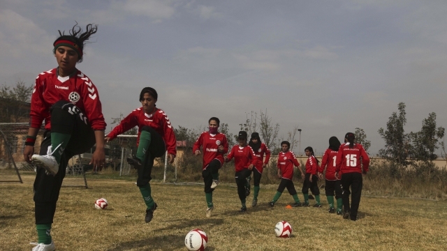 Members of the Afghan women's national football team warm up before a friendly match.