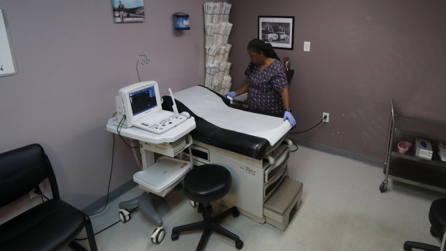 A woman prepares the operating room at the Whole Woman's Health clinic in Fort Worth, Texas.