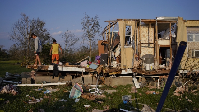 Aiden Locobon, left, and Rogelio Paredes look through the remnants of their family's home destroyed by Hurricane Ida