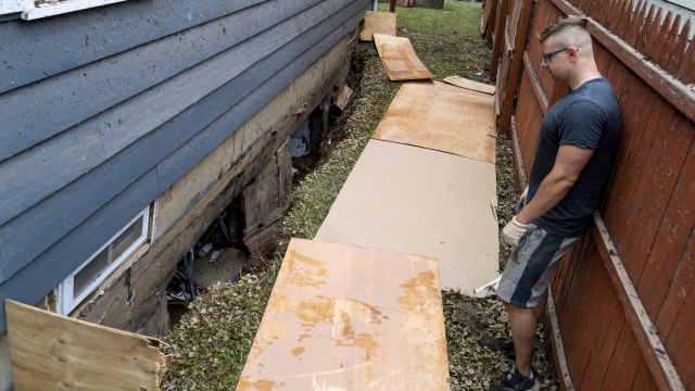 Simon Wolyniec stands near collapsed walls basement of his Manville, N.J., home Sunday, Sept. 5.