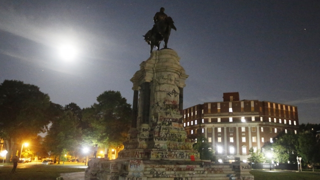 The moon illuminates the statue of Confederate General Robert E. Lee on Monument Avenue Friday June. 5, 2020, in Richmond, Va