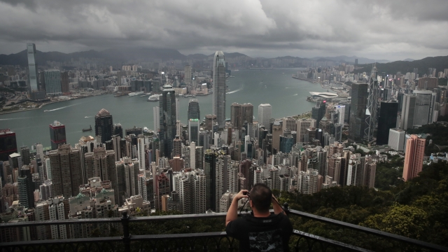 A visitor sets up his camera in the Victoria Peak area to photograph Hong Kong's skyline.