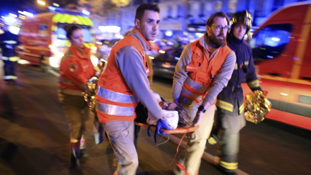 A woman is evacuated from the Bataclan concert hall after a shooting in Paris in 2015.