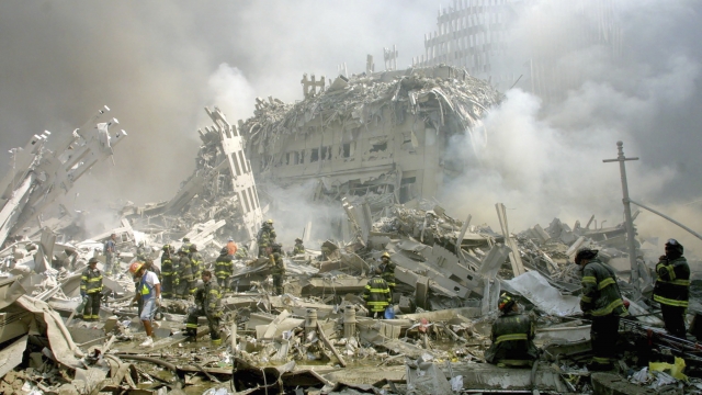 Firefighters make their way through rubble after terrorists crashed airliners into the World Trade Center on Sept. 11, 2001.