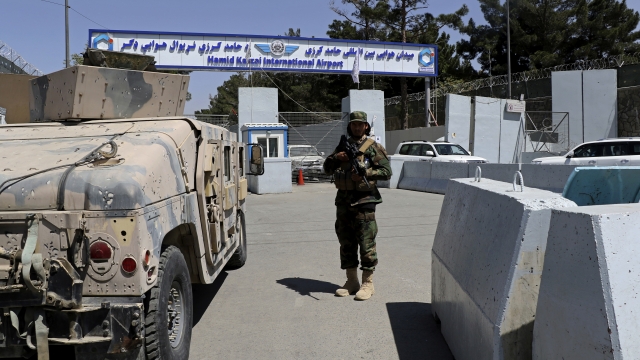 A Taliban soldier stands guard at the gate of Hamid Karzai International Airport in Kabul, Afghanistan, Sunday, Sept. 5, 2021