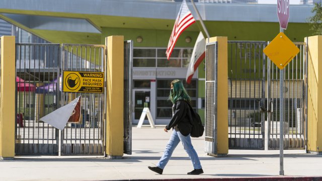 A student walks past the open doors of the Edward R. Roybal Learning Center in Los Angeles.