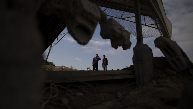 Palestinians inspect damage from Israeli airstrikes in the Gaza Strip.