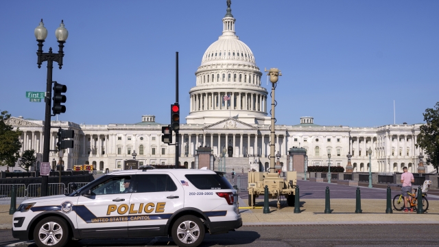 Police vehicle parked in front of the U.S. Capitol building.