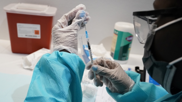 A syringe is prepared with the Pfizer COVID-19 vaccine.